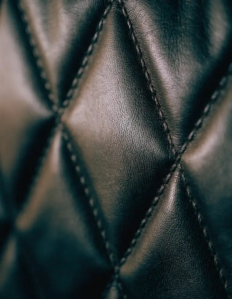 Quilted leather seating detail inside a Famous Drive vehicle